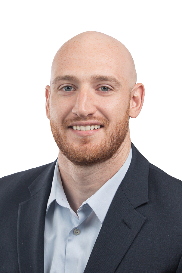 A man wearing a suit and tie smiling. Description generated by AI