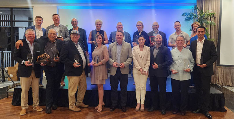 A group of people standing on a stage. Description generated by AI