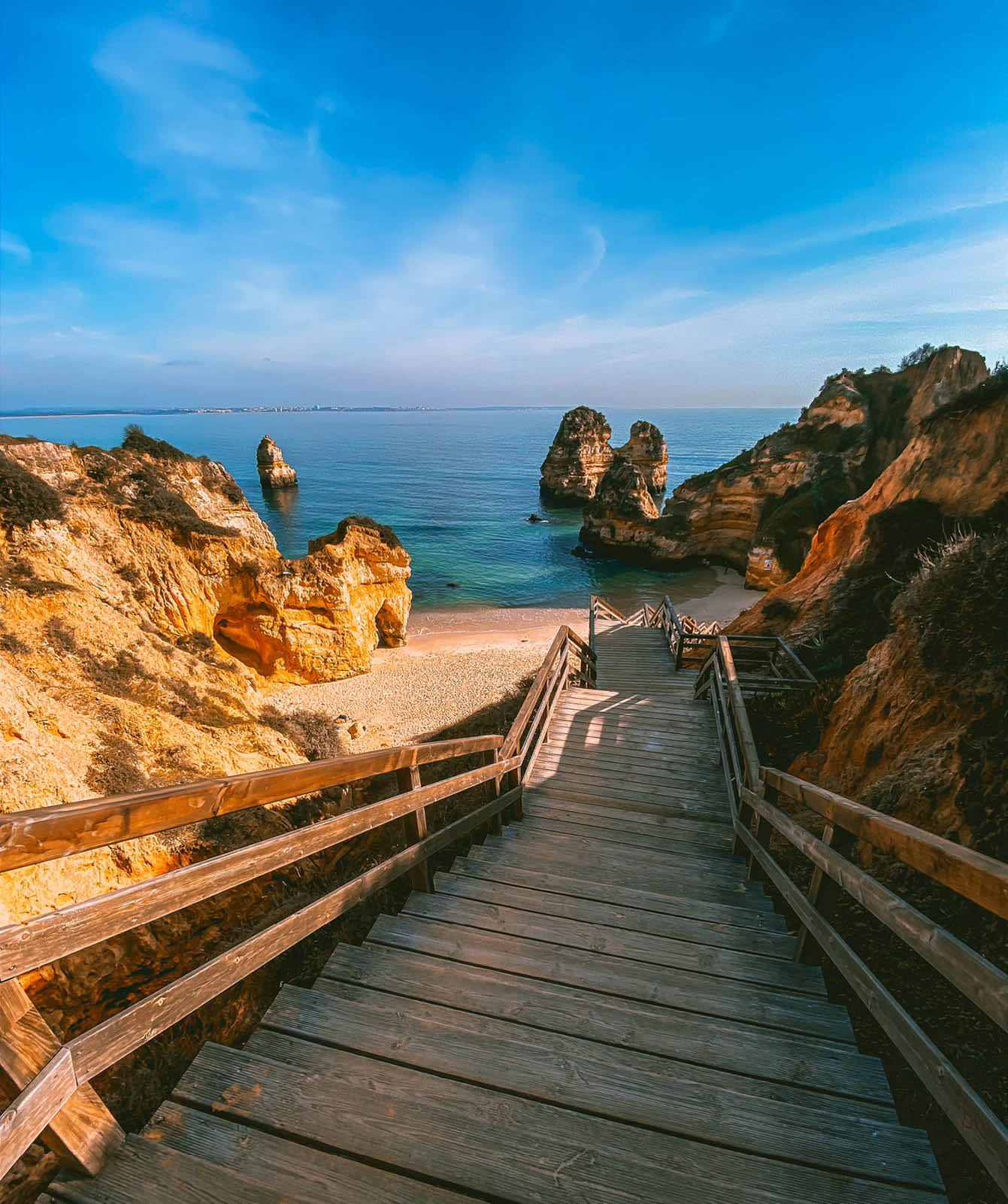 A wooden staircase leading to a beach. Description generated by AI